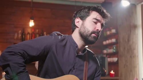 Bearded Man Plays Acoustic Guitar and Sings