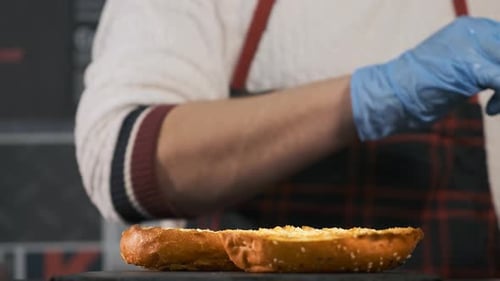 Close-up Top View of a Cook's Hands Cooking a Hamburger.