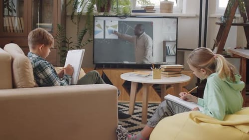 Boy and Girl Learn Online From Teacher