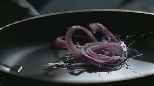 Red onion into pan with oil in super slow motion, shot on Phantom Flex 4K