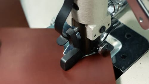 Leather Being Trimmed By a Manufacturing Machine