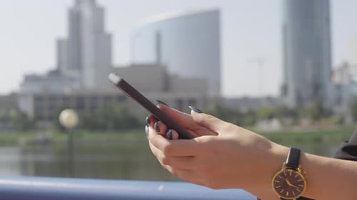 Woman Using Smartphone in City