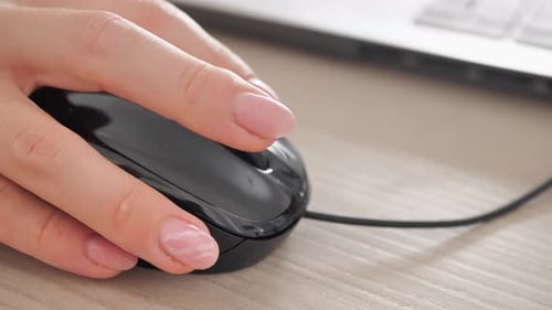 Closeup of Businessman's Hand Using Mouse Click and Move on Table at Home or Office