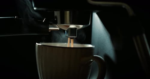 Espresso Pouring into Mug from Coffee Machine