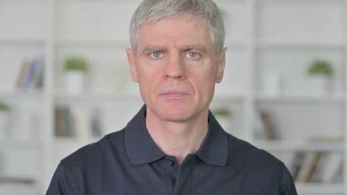 Mature Man Massaging Sore Neck in Home