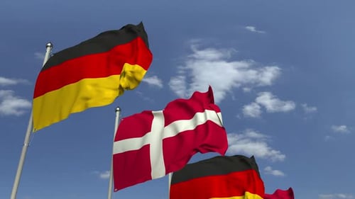 Waving Flags of Denmark and Germany on Blue Sky