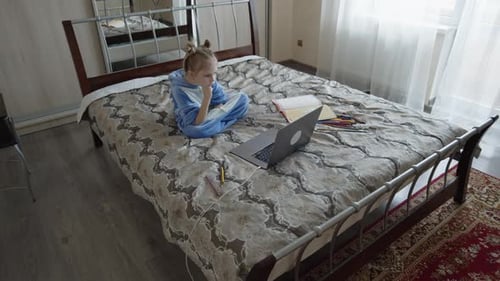 Girl on Bed Using Laptop for Remote Learning