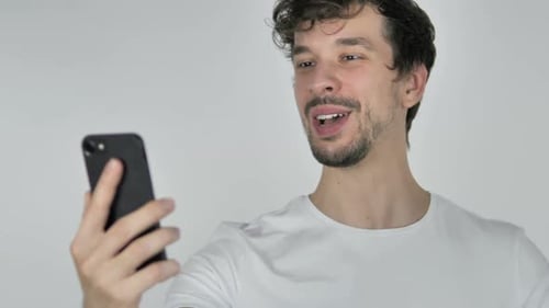 Young Man on Smartphone Video Call Smiling