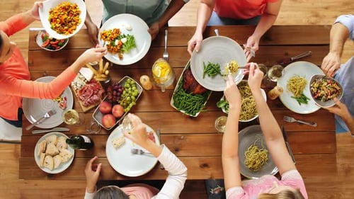 Friends Sharing Delicious Food at a Dinner Table