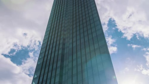 Timelapse Modern Skyscraper Glass Surface High Office Building Blue Sky and Clouds Moving Fast