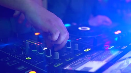 Disc Jockey Manipulating Mixer At Urban Concert