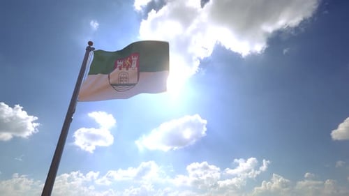 City Flag Waving Proudly Against Sunny Blue Sky