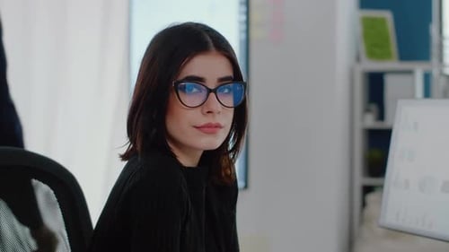 Portrait of Woman with Business Job Sitting at Office Desk