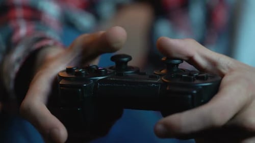 Close up of hands using a video game controller