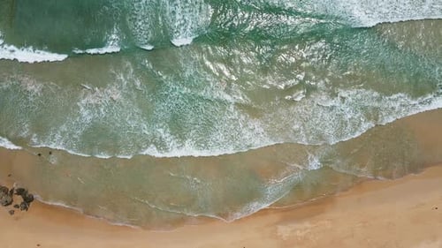 Aerial view of white sand beach and ocean wave