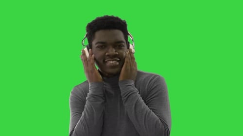 Man with Headphones Dancing on Green Screen