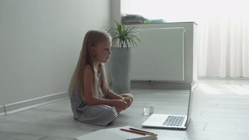 Young Girl Using Laptop for Education at Home