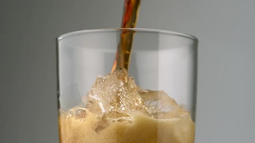 Brown Soda Poured Over Ice Close Up