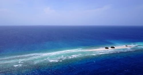 Daytime drone copy space shot of a white paradise beach and blue water background