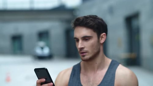 Closeup Athlete Man Looking Smartphone on Street, Smiling Man Reading Message