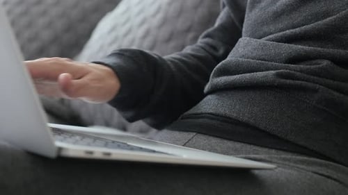 Female using laptop for working at home 4K close-up video