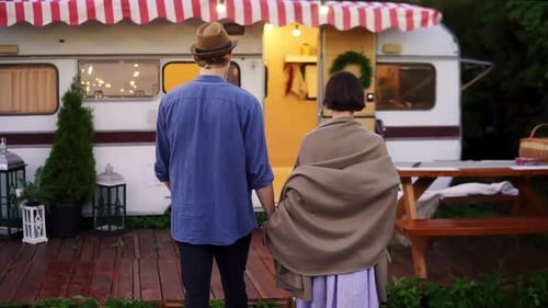Romantic Couple Living or Having Vacation in Trailer Girl Covered with Brown Plaid Walking with Her