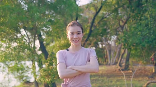 Asian active sport woman stand with confidence after exercise outdoors.