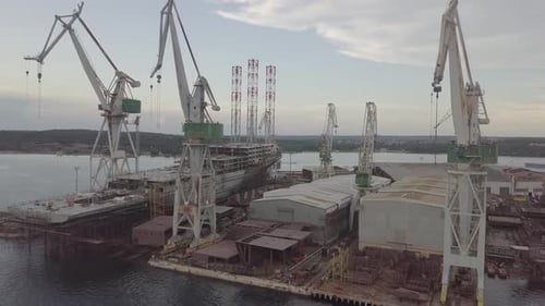 Aerial View of a Shipyard and Shipbuilding Cranes