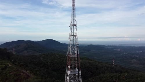 Aerial view ascending telecommunication tower at hill