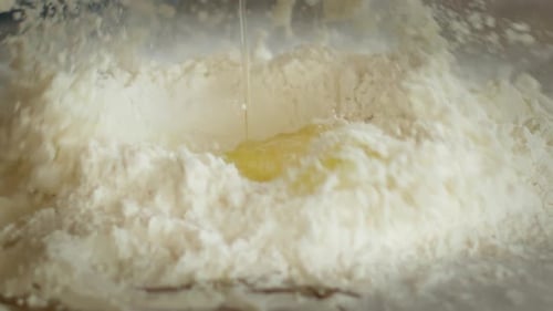 Close Up Falling Eggs Into Flour
