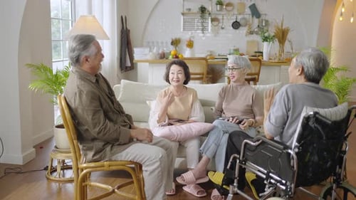 Seniors Conversing and Laughing Together in a Living Room