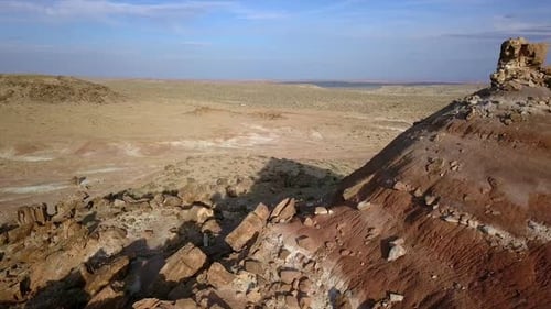 Flying backwards revealing red dirt hill in the Utah desert