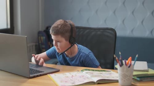 Child Learning Online at Desk with Laptop