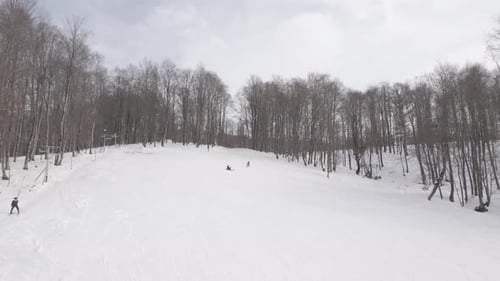 Aerial view of the ski resort with snowy mountain slopes and winter trees.