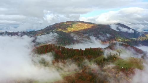 Flight Through Blue Sky with Clouds Over Mountain