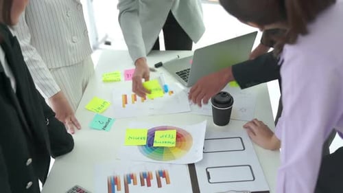 Creative Team Collaborating on Mobile App Design in Office