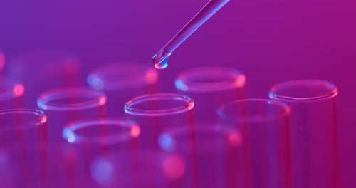 Liquid Being Dropped into Test Tubes