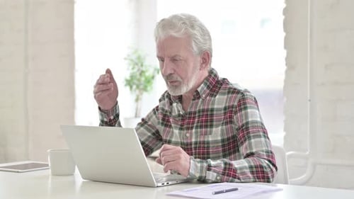 Mature Man Uses Laptop for Video Conference