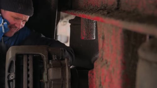Man Adjusting The Brakes