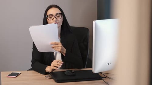 Brunetter Business Woman Working at the Office with Papers
