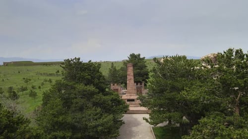 Stone Obelisk in Green Field from Above