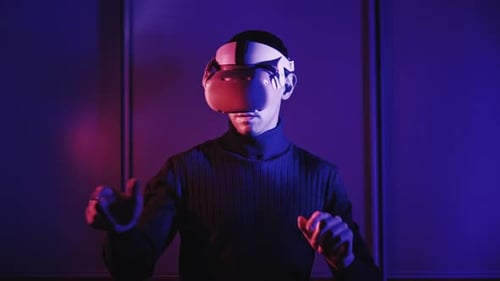 Man Uses VR Headset in a Futuristic Setting