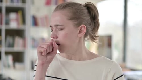 Young Adult Woman Coughing in a Close Up Shot