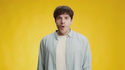 Surprised Young Man Opens Mouth Wide in Shock