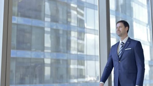 Two Middle Aged Businessmen Shaking There Hands and Talking in Office