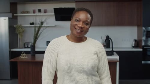 Smiling Woman in Modern Kitchen Setting