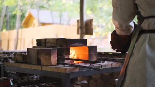 Blacksmith Shaping Hot Metal in Rural Forge