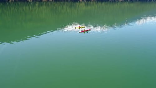 People kayaking in lake 4k
