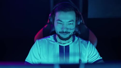 Intense Young Man Gaming with Headset