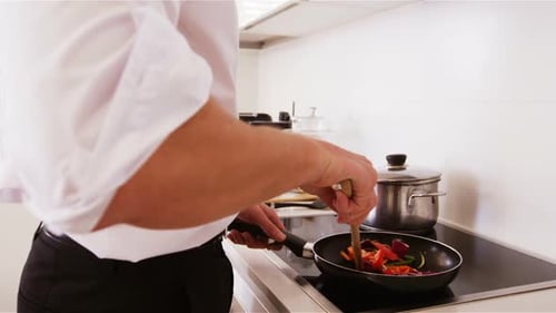 Man Cooking Healthy Vegetables in a Modern Kitchen